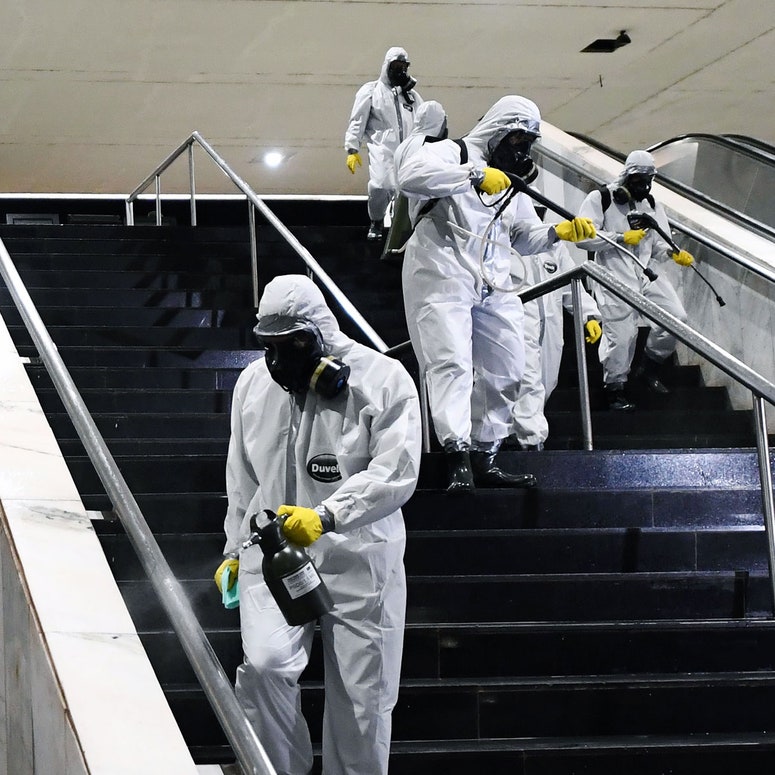 sanitation workers cleaning stairs