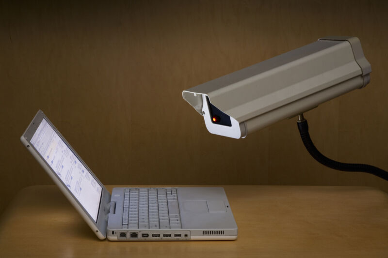 Surveillance camera peering into laptop computer