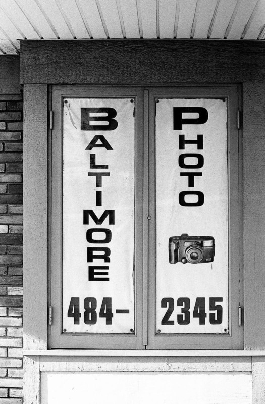 The front doors of a camera repair shop in Baltimore