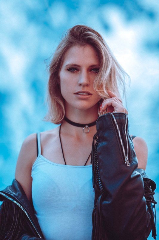 A woman posing against a do-it-yourself dappled light backdrop